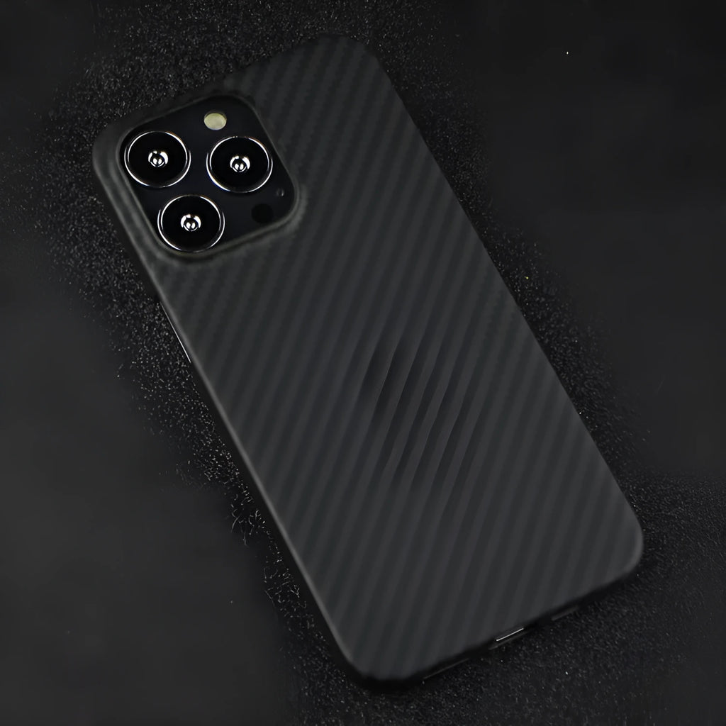 Dull black Kevlar fibre back cover case for Apple iPhone with MagSafe ring visible.