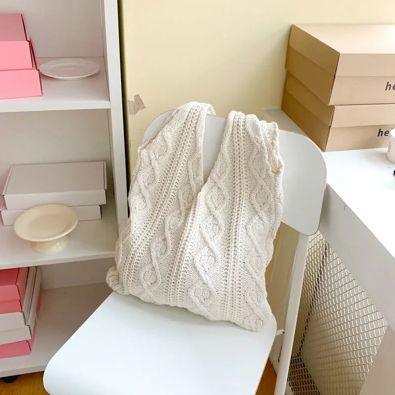 GWomen retro crochet shoulder tote bag in a solid colour, showing knitted texture and double strap connectors.
