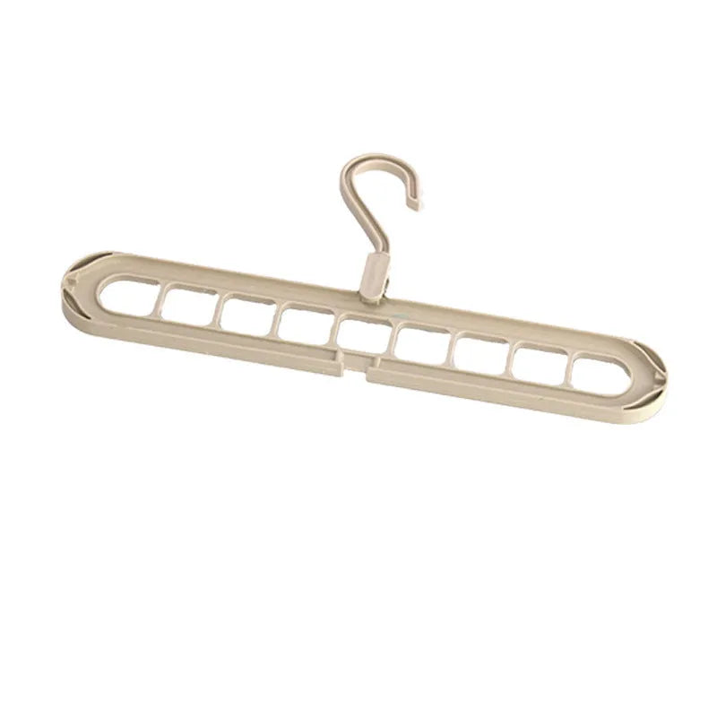 Green nine-hole plastic folding hanger for trousers and skirts showing multiple garment hanging points