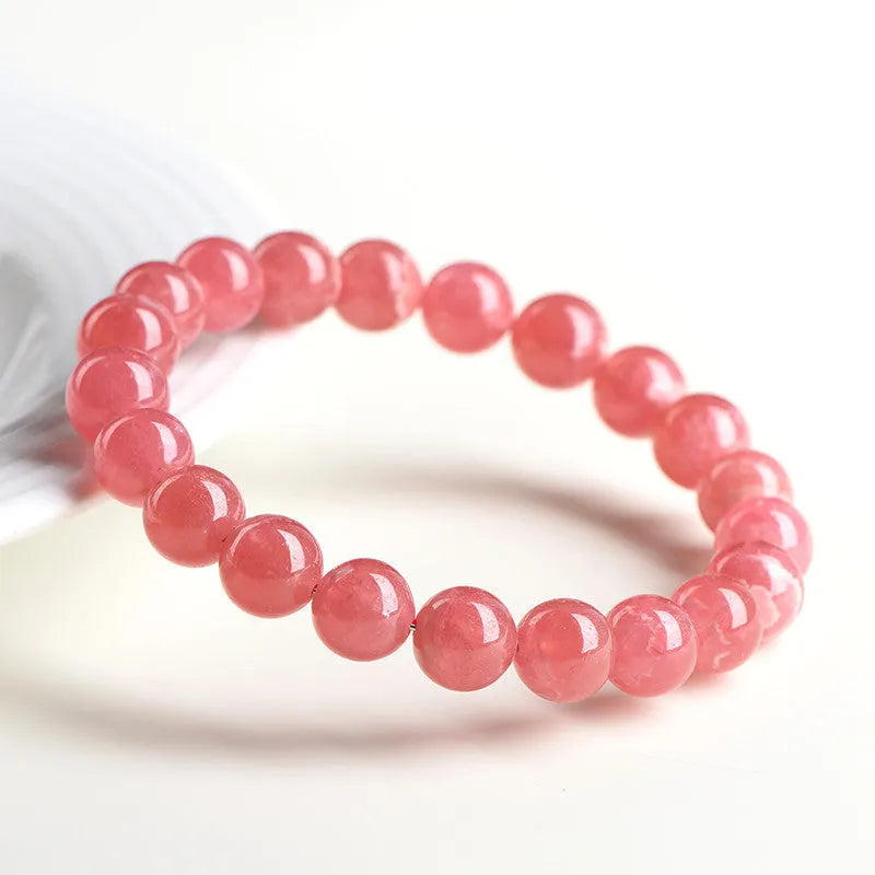 Women's geometric crystal bracelet with a longevity lock, shown in rhodochrosite colours.