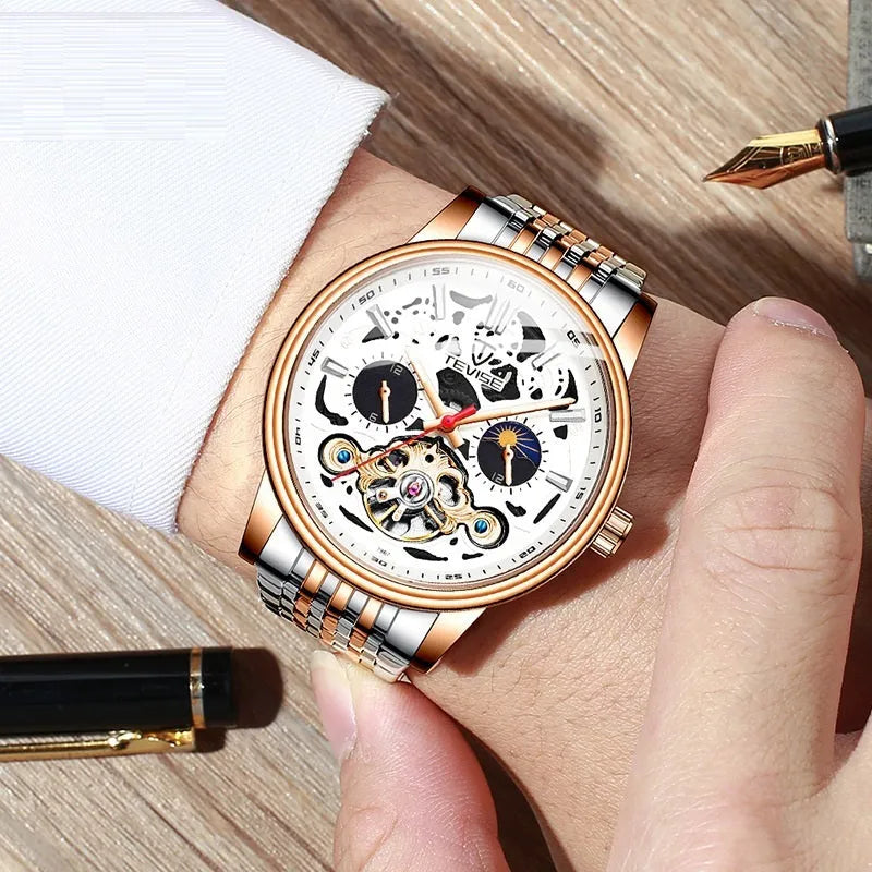Men's tourbillon mechanical watch with luminous hands on a steel bracelet, showing a black dial.
