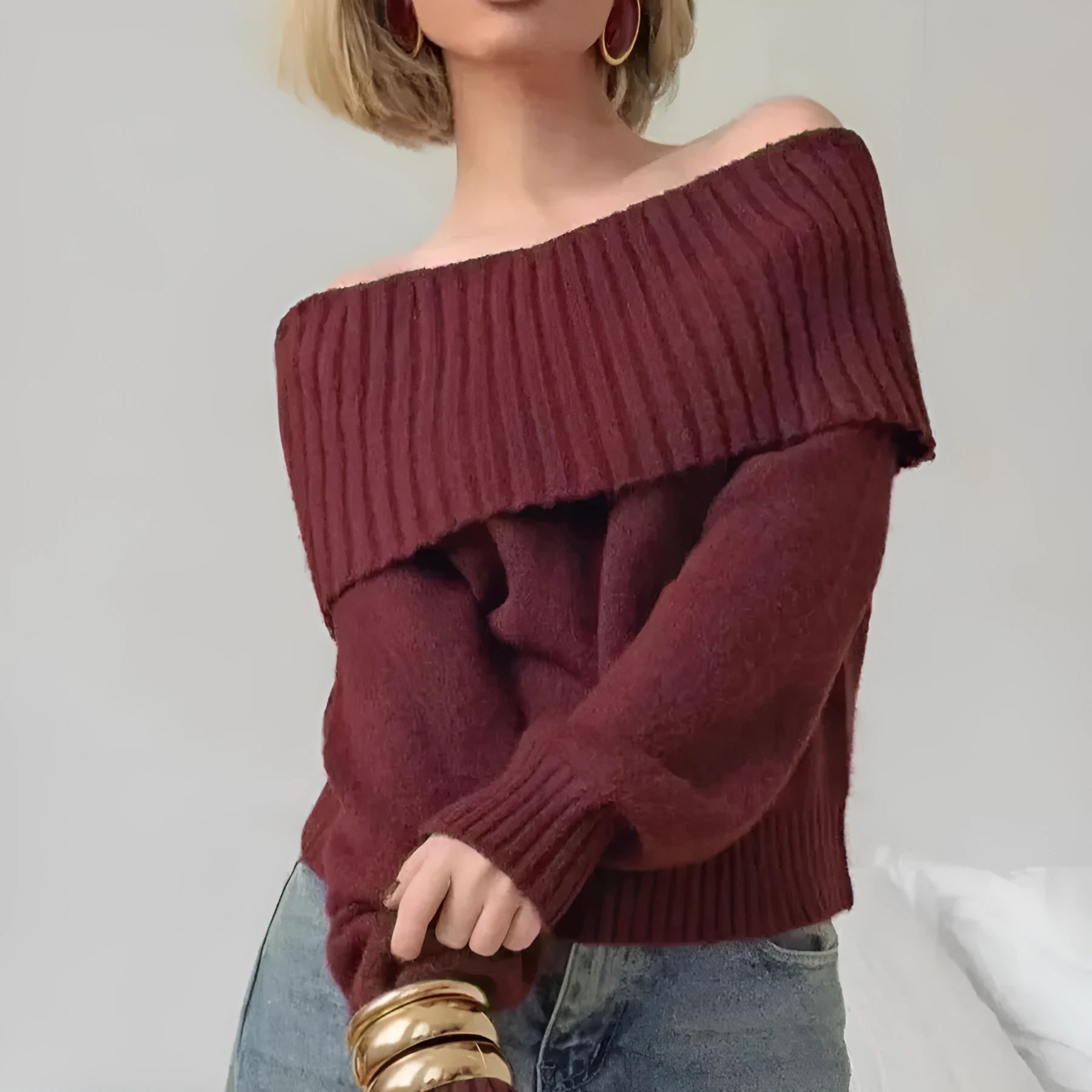 Grey off-the-shoulder sweater with a 3D pattern, shown on a model.
