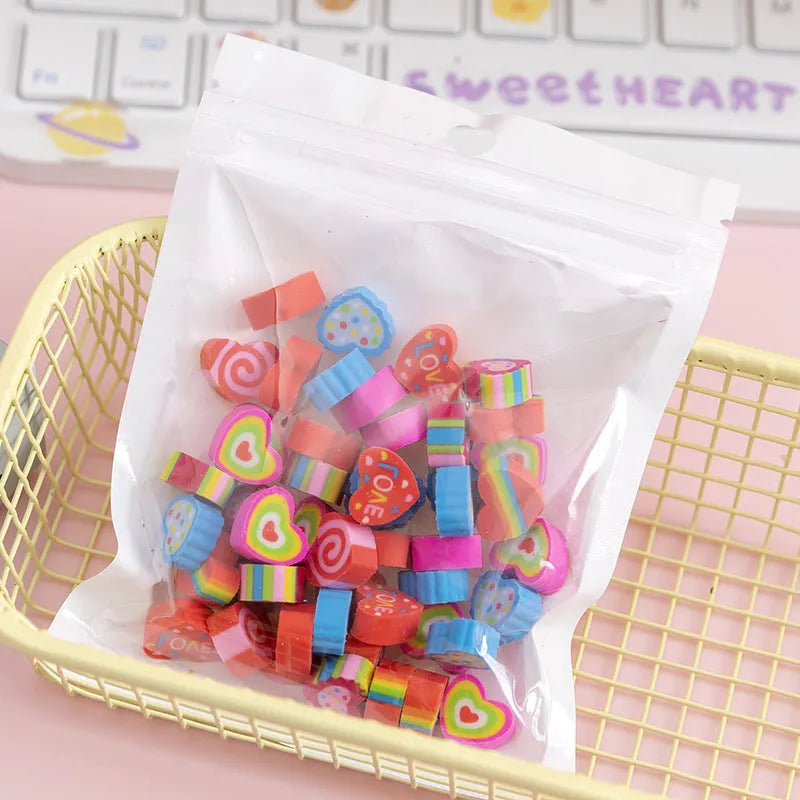Sealed plastic bag containing 50 small cartoon-themed erasers in shapes like fruits, animals, and Christmas symbols.
