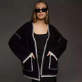 Lace-up front knitted cardigan in black, camel, or white, showing loose fit and thick fabric.
