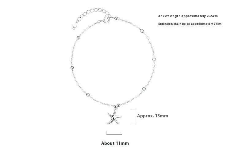 Close-up of a sterling silver anklet with round beads, a starfish charm, and an extender chain on an ankle.