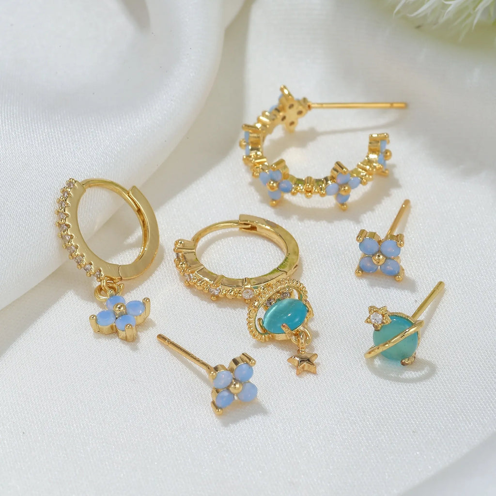 Gold and silver floral ear studs with blue zircon flower nail detail in Japanese Korean style
