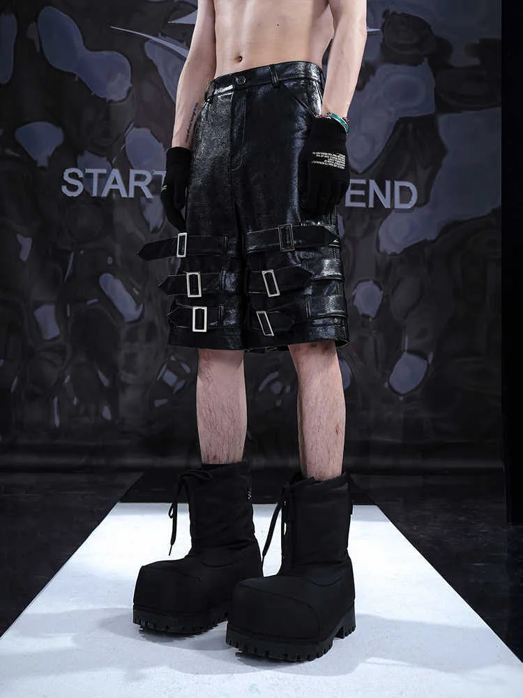 Black men's leather-look casual cropped shorts with ring details on a low-rise waist.