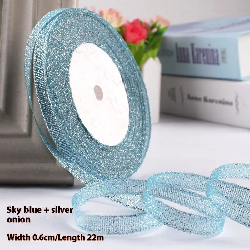 Roll of narrow 0.6cm wide polyester gift ribbon in a multicolour pattern.