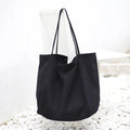 Large canvas shoulder tote bag in solid colour with soft handle, open top, and internal phone pocket