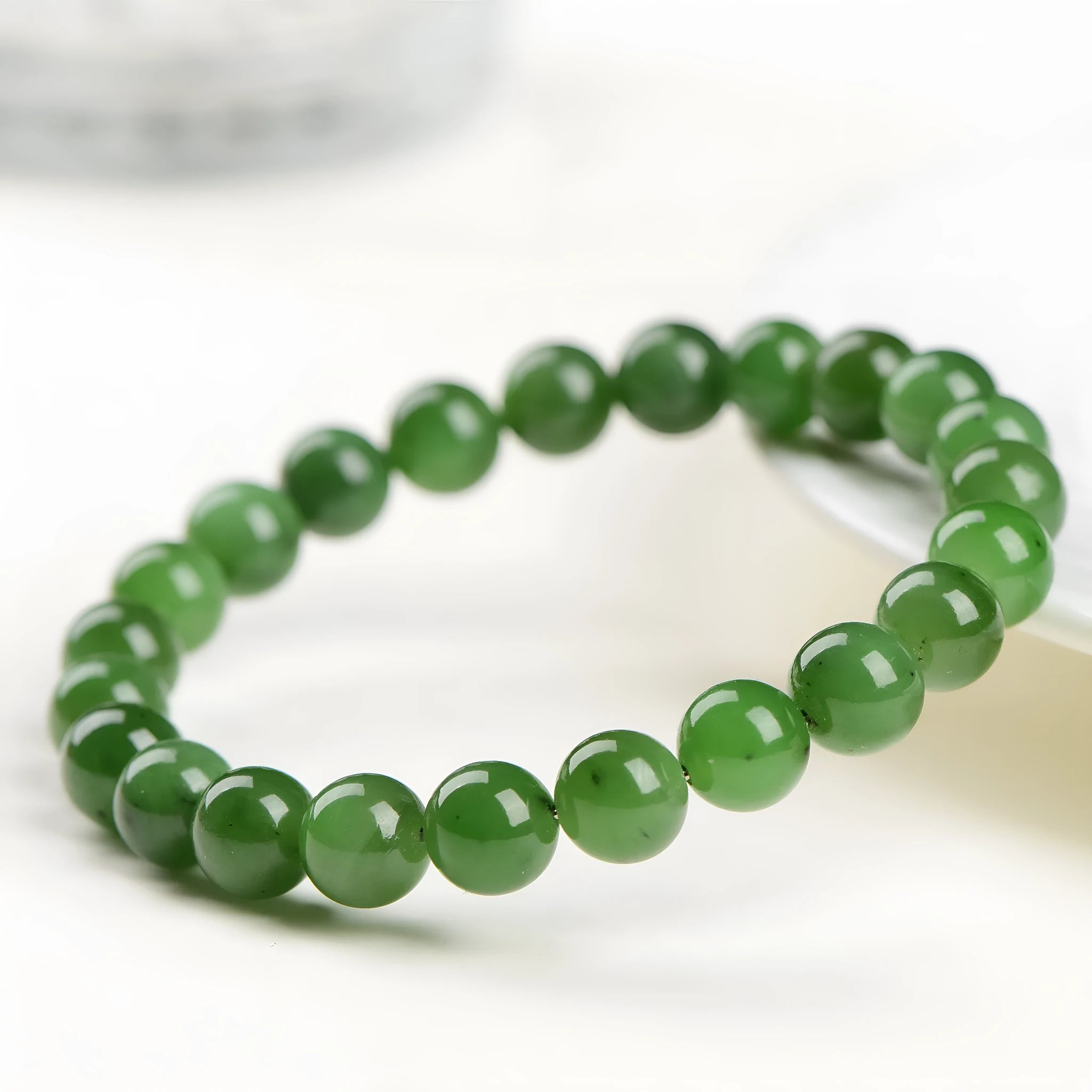 Polished natural jasper bead bracelet in Hetian jade, showing multiple bead size options on a wrist.
