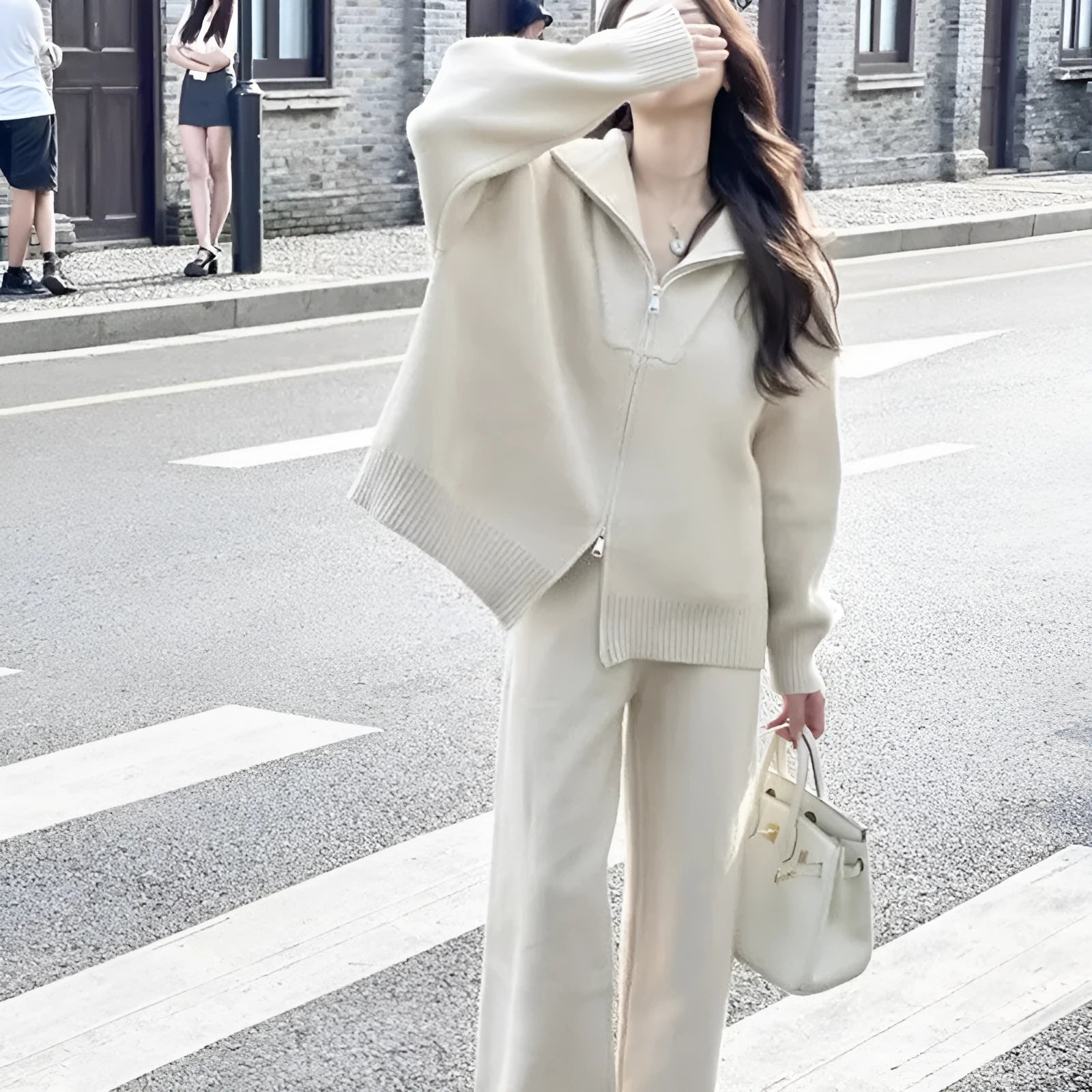 Women's knitted polyester two-piece set with zipper cardigan and wide-leg trousers in a solid colour.