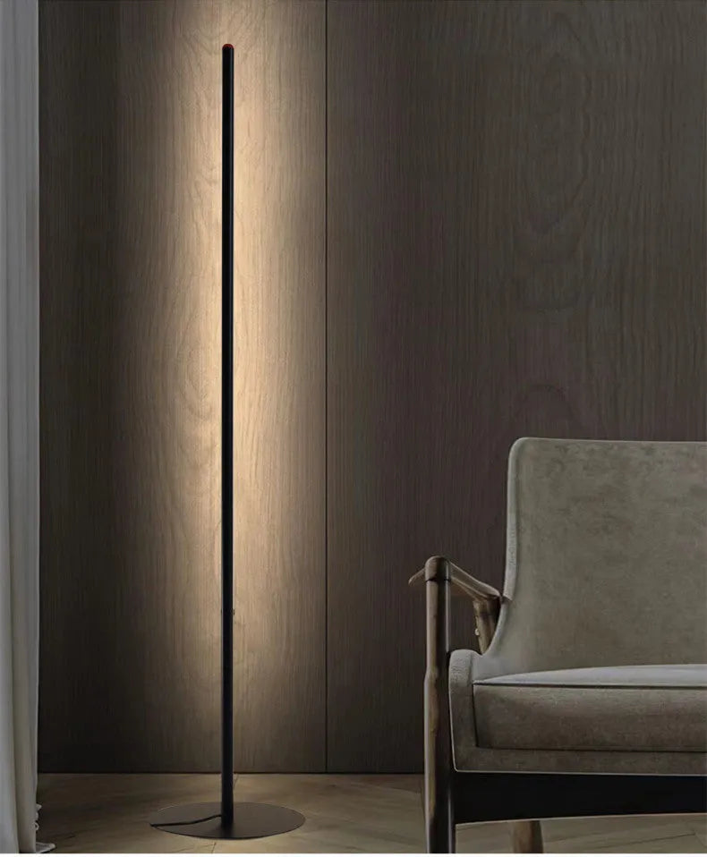 Simple vertical aluminium alloy floor lamp with a USB plug, shown beside a sofa.