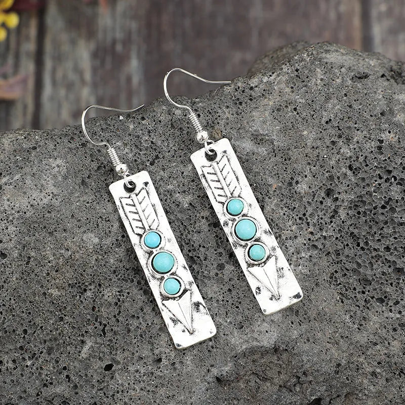 Women's silver geometric long strip earrings with turquoise detail and retro styling