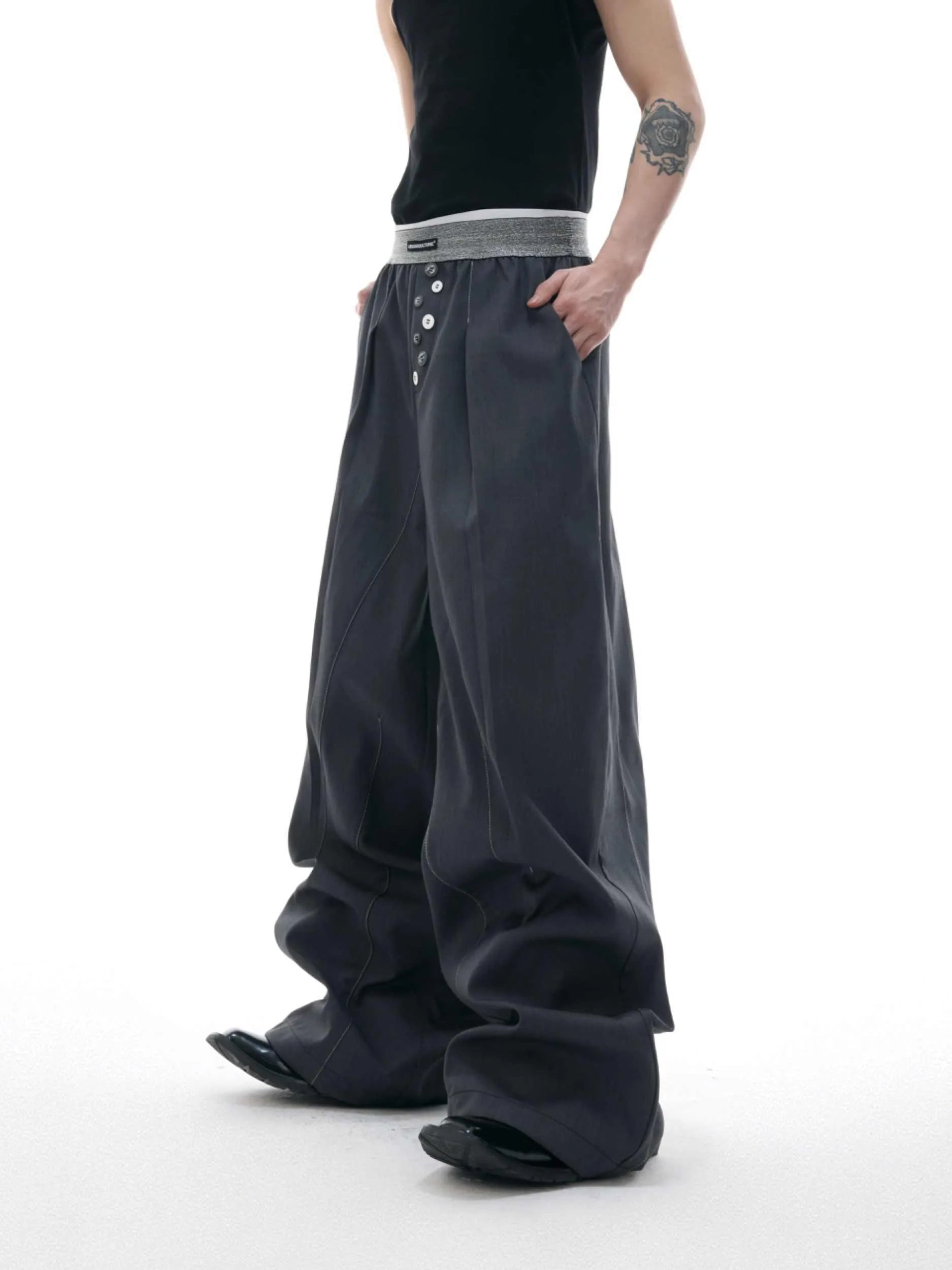 Straight-leg high-waisted casual trousers with a button-open front seam detail in black.