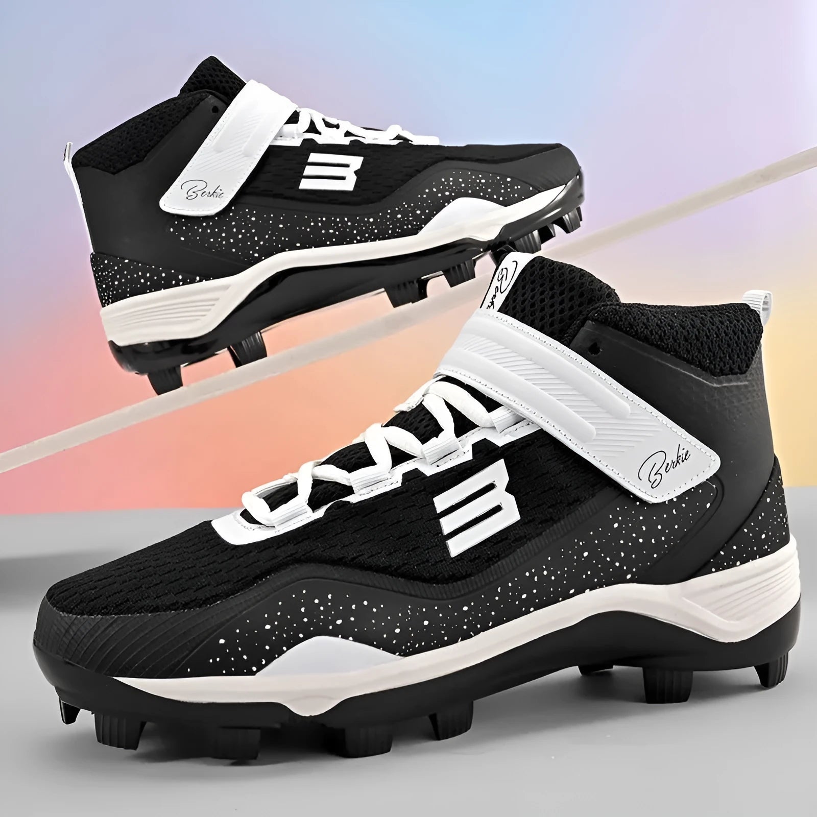 Black and white middle top baseball shoes with Velcro straps and a rubber sole.