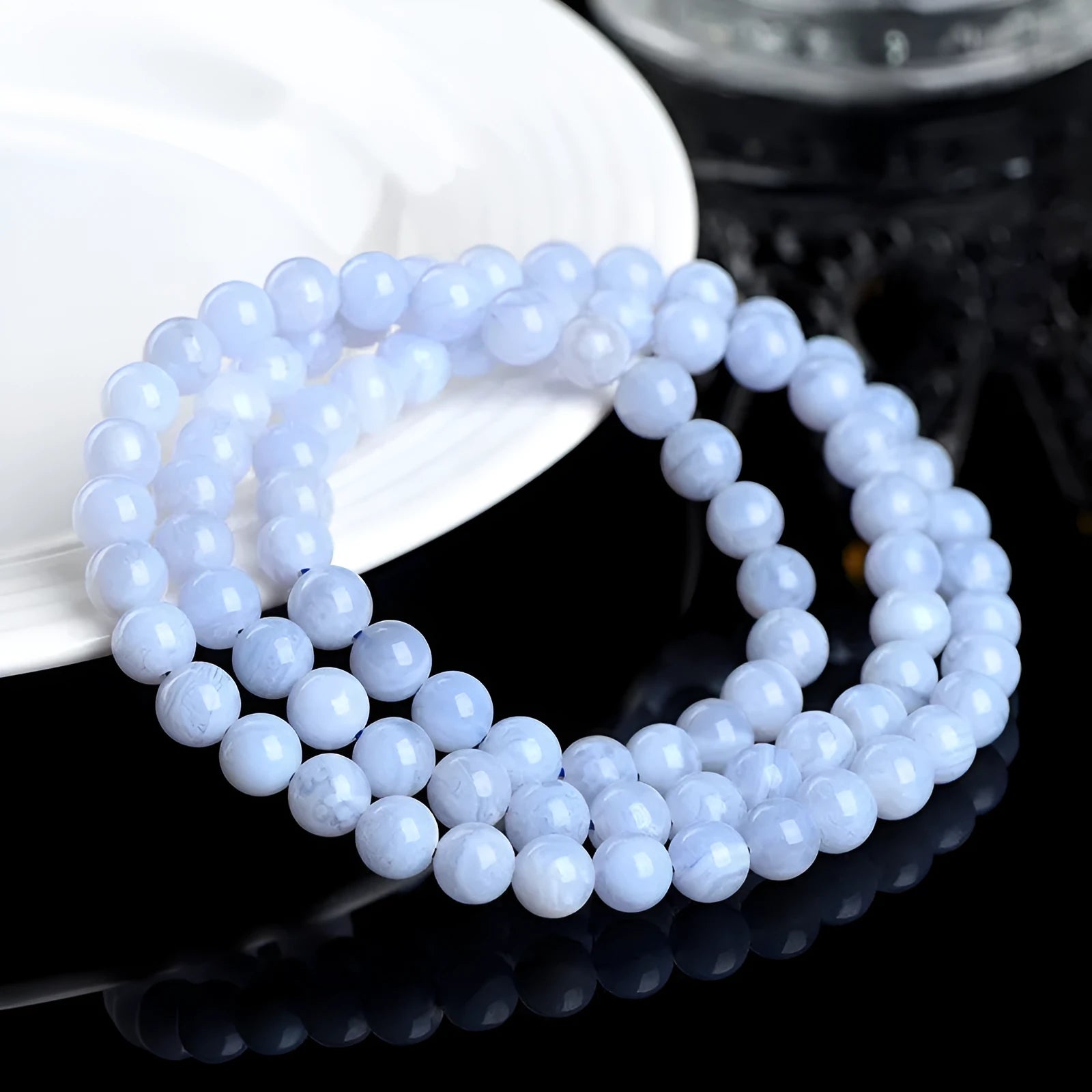 Blue agate bracelet with Ruyi symbol and scattered beads measuring 6-6.8mm.
