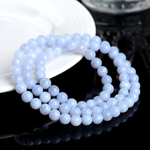 Blue agate bracelet with Ruyi symbol and scattered beads measuring 6-6.8mm.