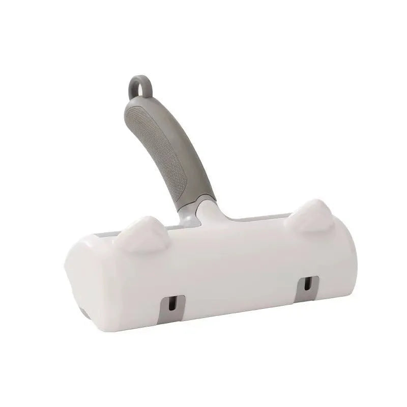 Mint green and twilight grey cat hair removal brush with two head style options on a white background.