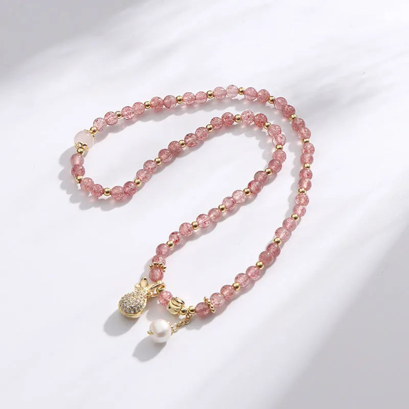 Geometric strawberry quartz crystal bracelet for women on a white background.
