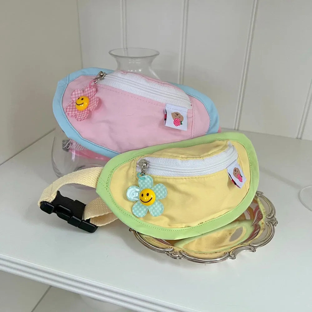 Pink and yellow messenger-style pet backpack for dogs and cats with poop bag feature