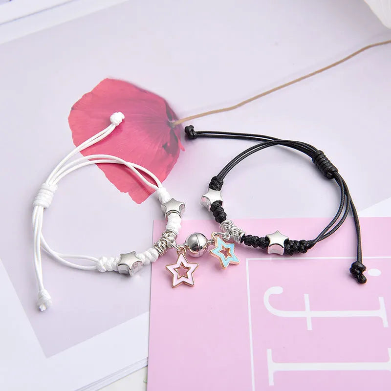 Magnet suction couple bracelets with alloy construction and various pendant designs including crowns and hearts