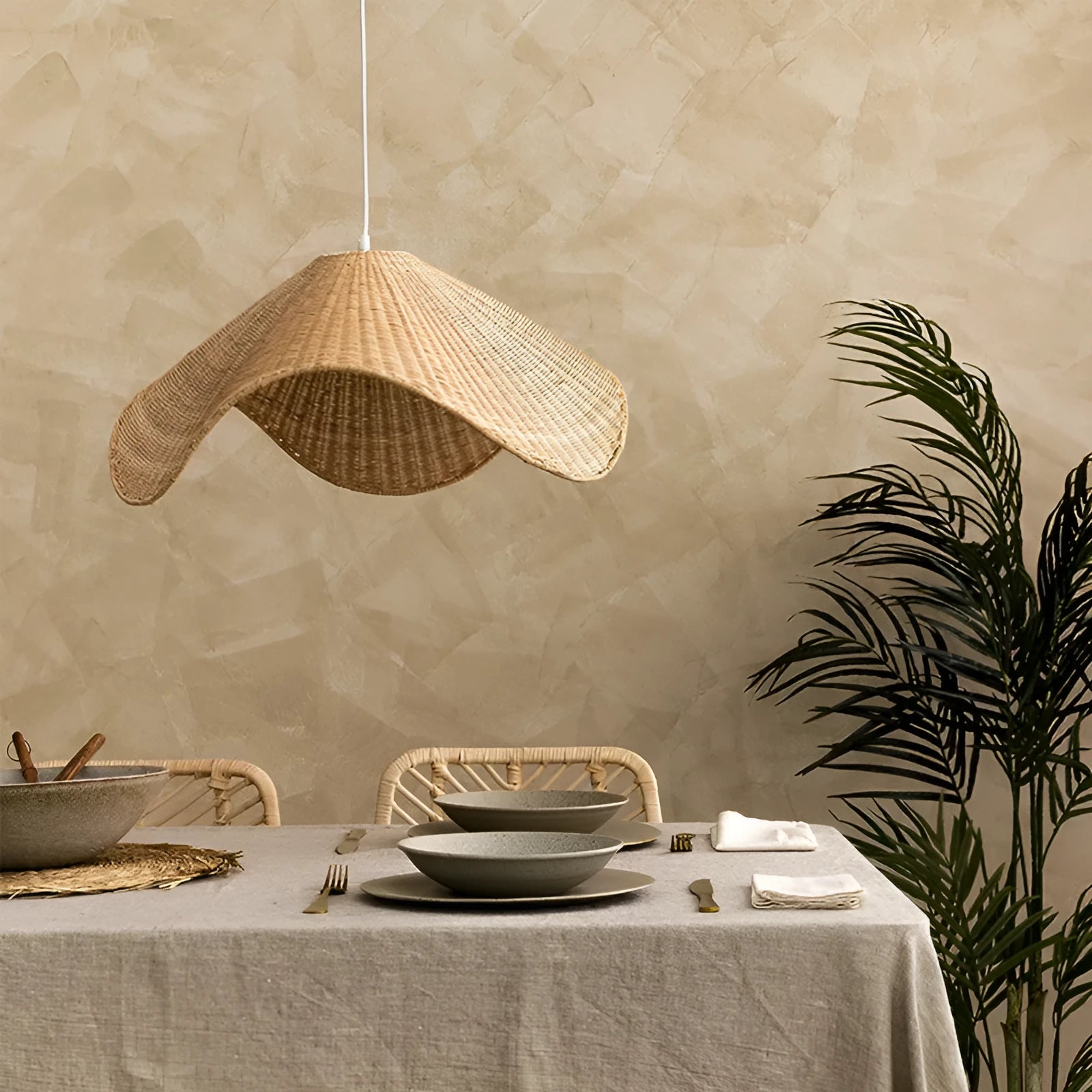 Handmade bamboo rattan chandelier with woven straw and willow lampshade in warm light