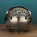 Bronze alloy ashtray with decorative fortune tree design and smoke extinguishing slot.