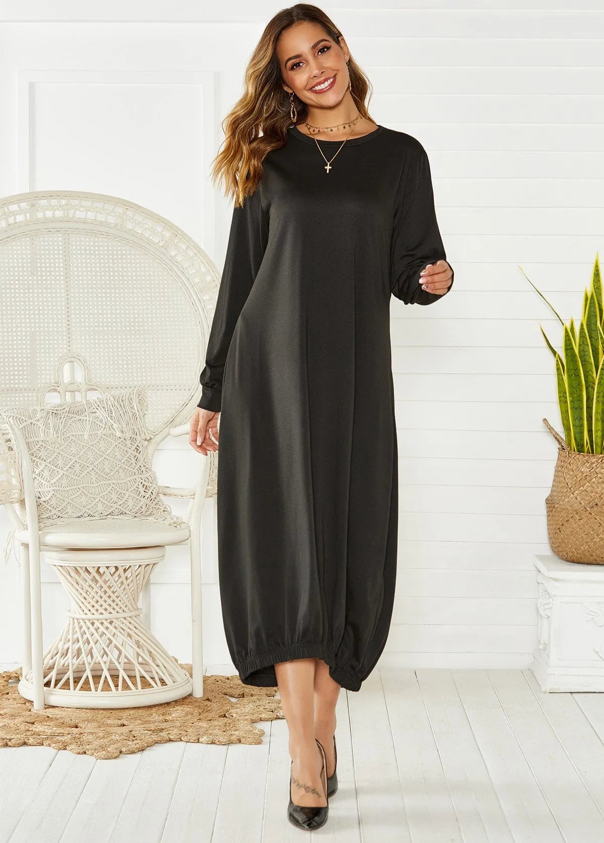 A loose-fitting black lantern dress for women with a lace-up crew neck.