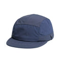 A person wearing a khaki dome cap with a soft tongue and dome crown for sun protection.