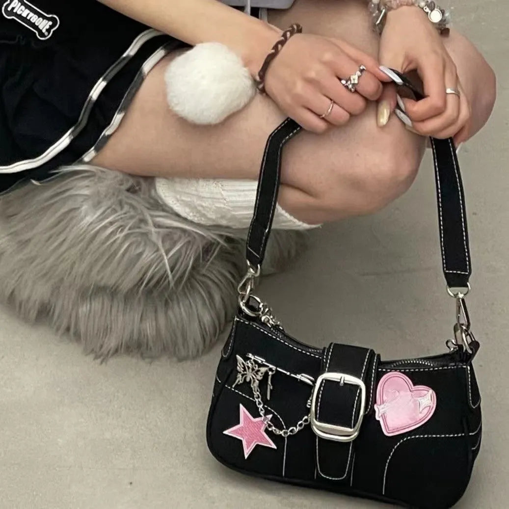 Black PU leather Y2K shoulder bag with heart butterfly shape, bow, stitching, chain, and zipper buckle