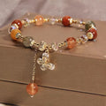 Coloured hair crystal bracelet with single circle design and chosen charm: cat's paw, purse, flower, or zircon butterfly