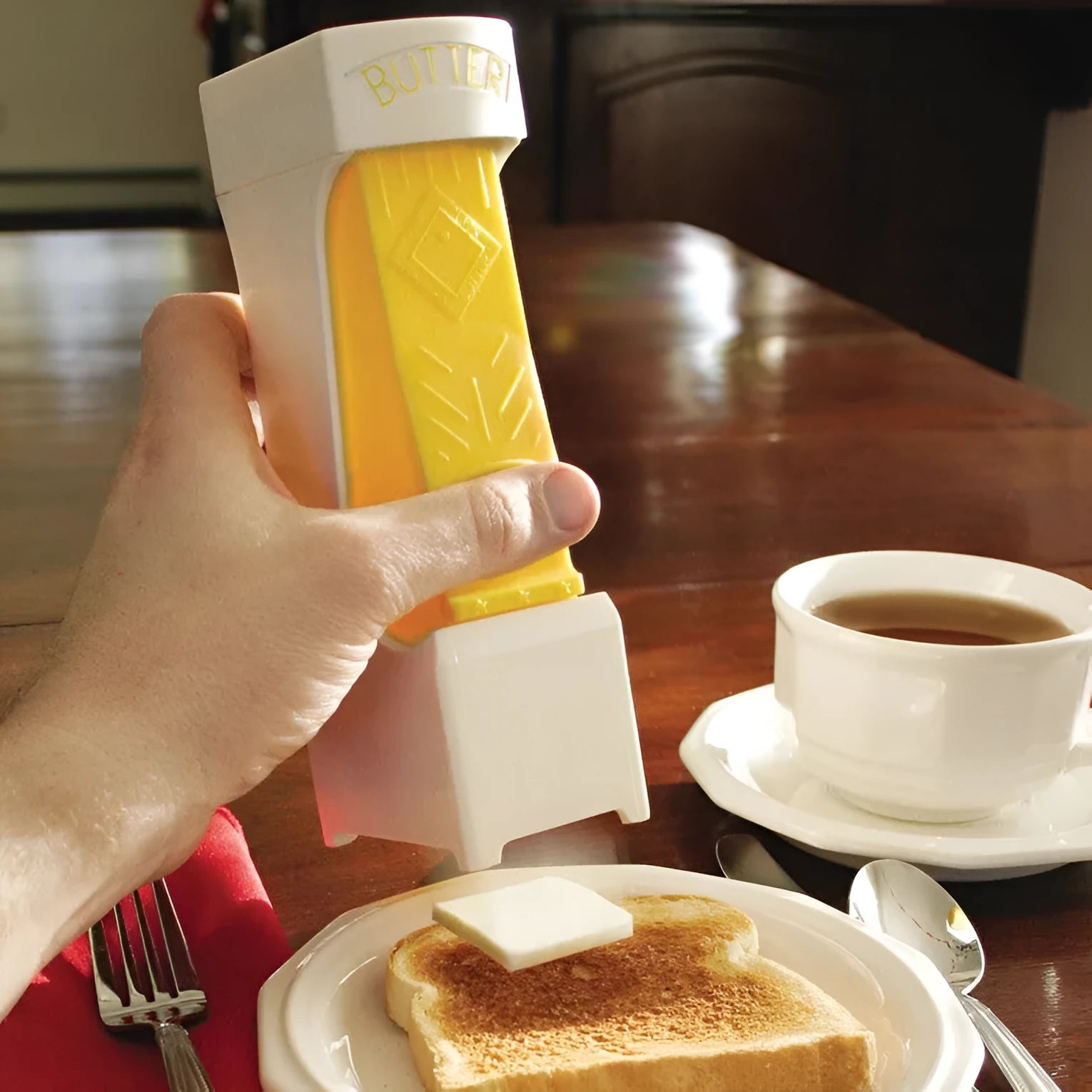 Yellow ABS plastic butter cutter with one-button dispenser and stainless steel blade for 4.75-inch bars
