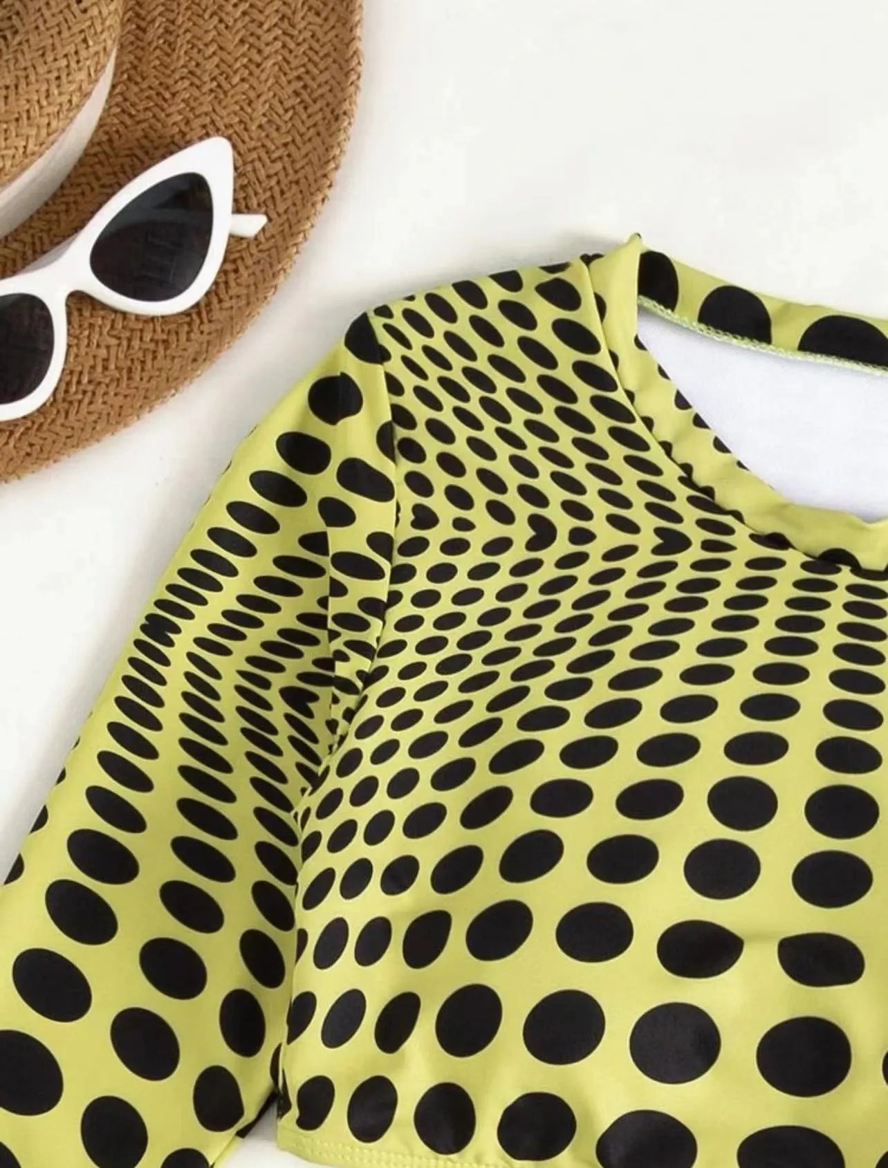 Green and yellow polka dot women's three-piece swimsuit set showing top, skirt, and bra.