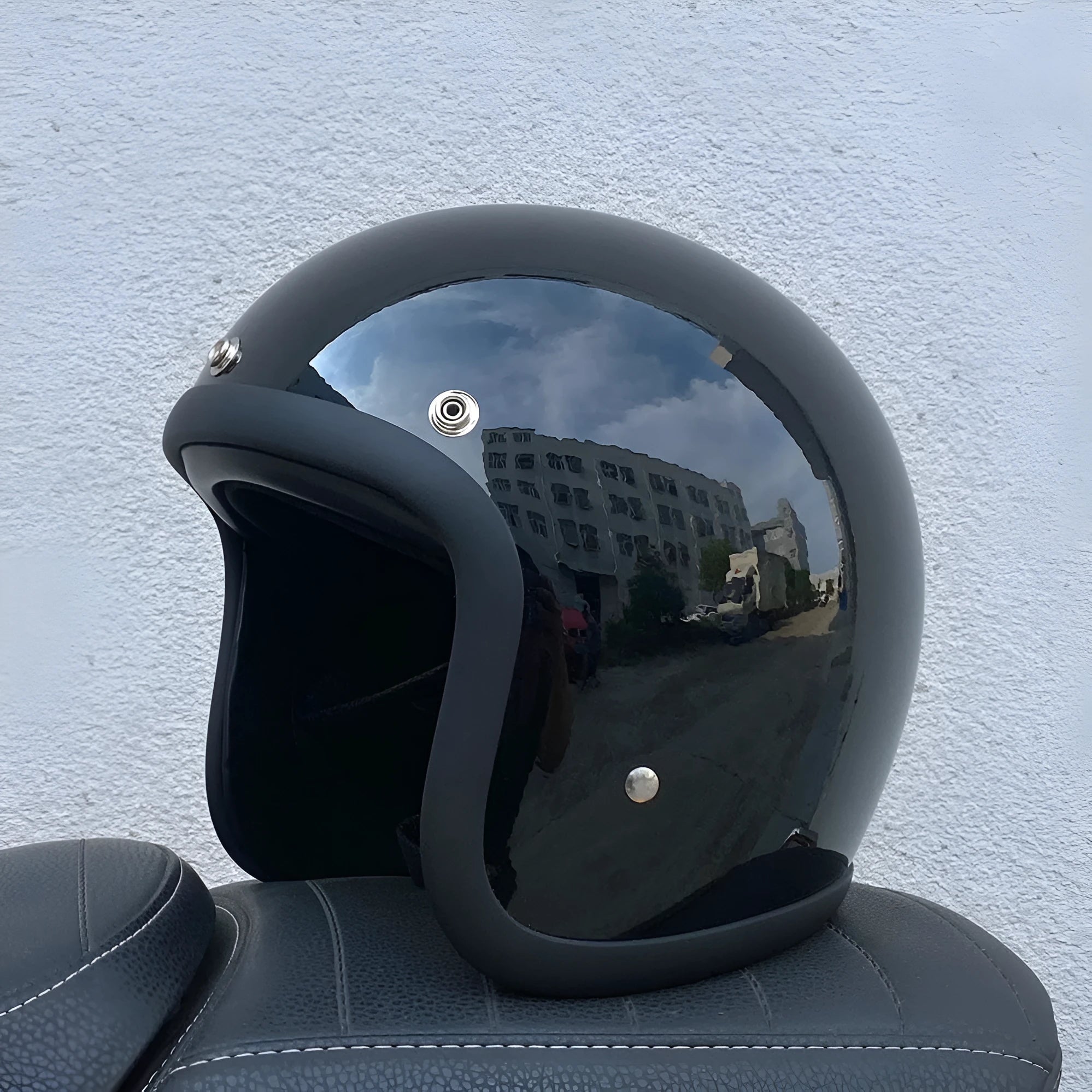 Retro-style open-face motorcycle helmet in fibreglass, shown in a choice of colours including Cement Grey and Matte Black Flower.