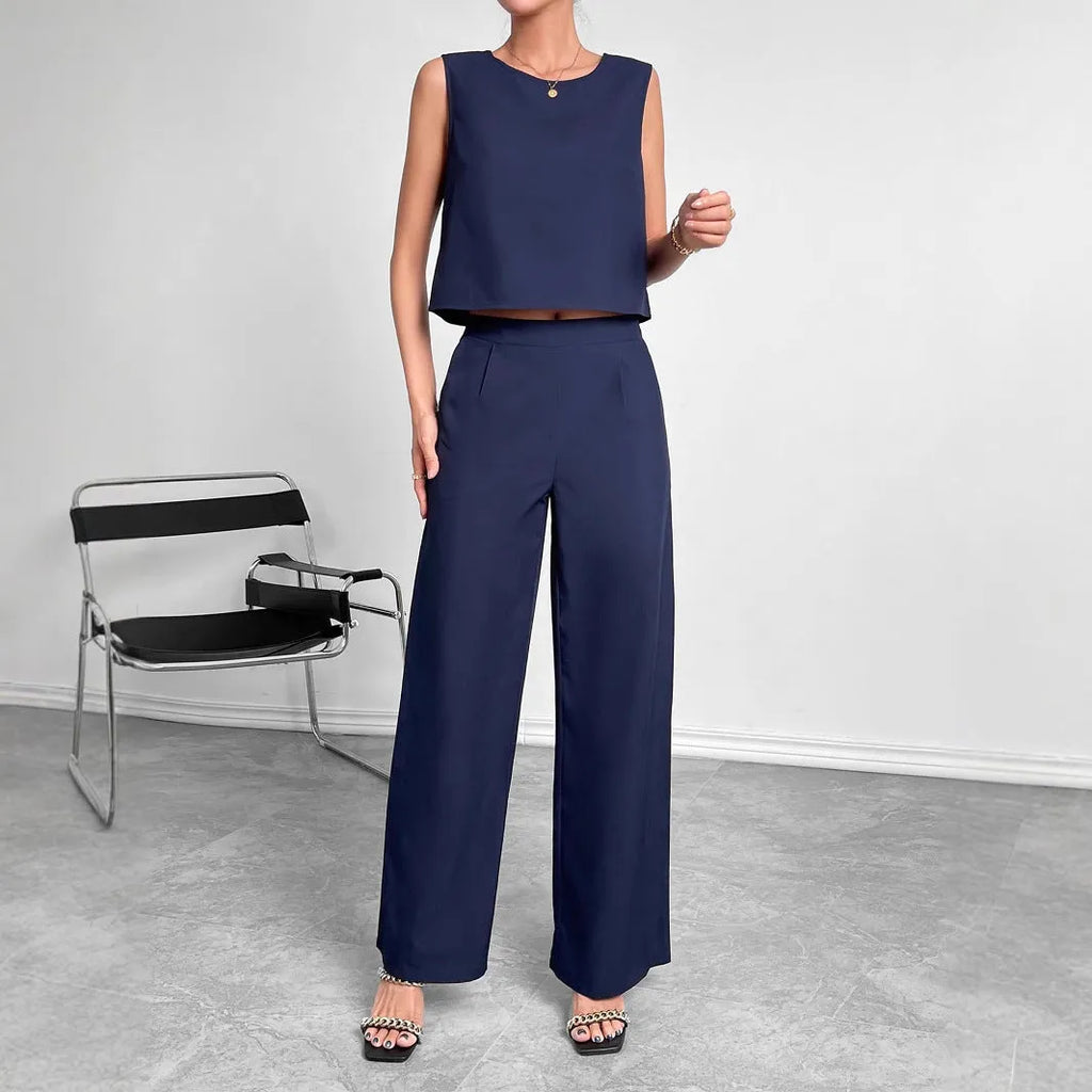 Red women's sleeveless top and wide leg trousers two-piece co-ord set.