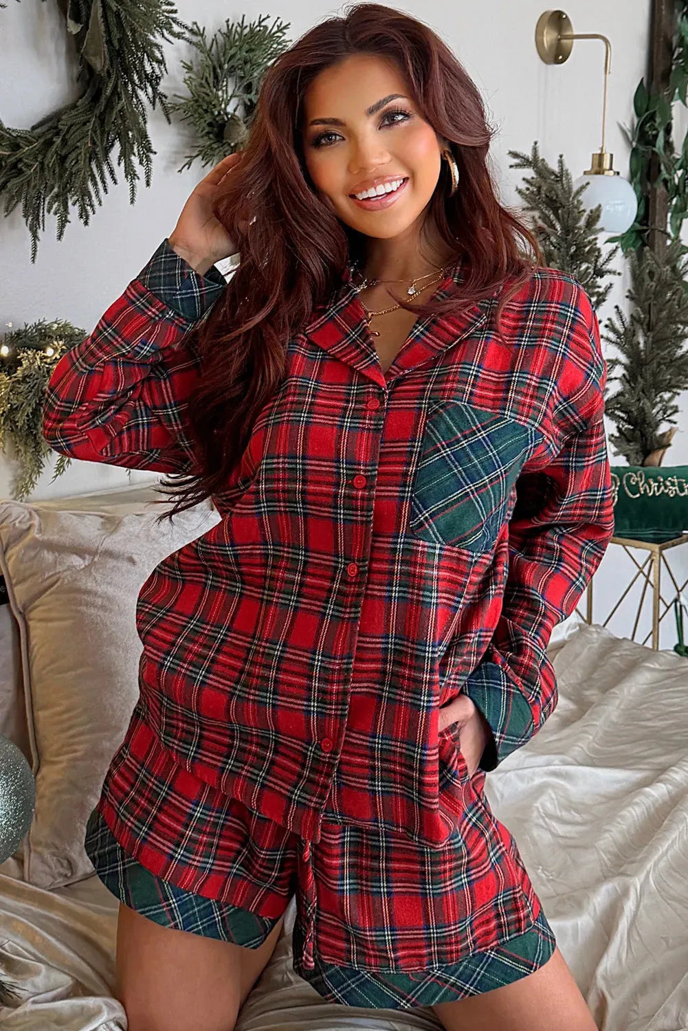 Red plaid Christmas pyjama set with contrast patches on shirt and shorts, laid flat.
