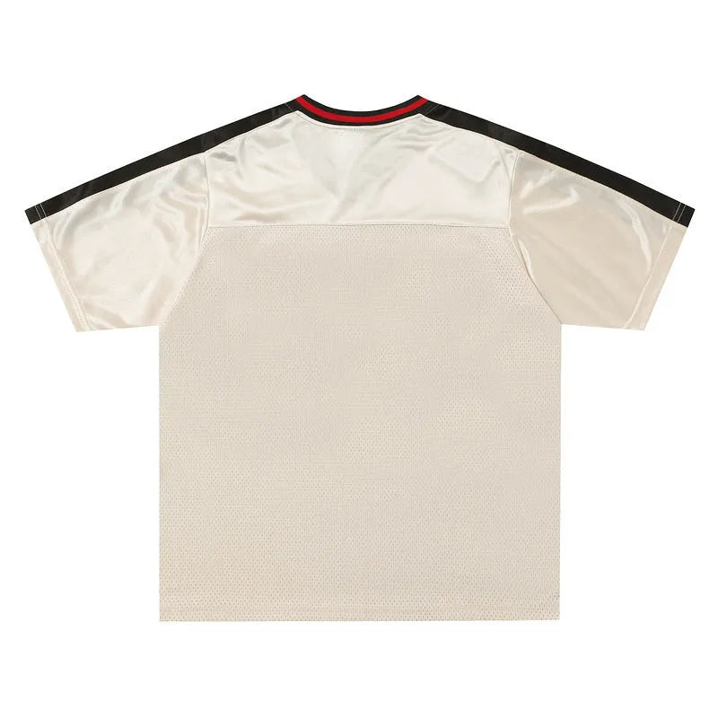 Apricot coloured loose fit V-neck sports jersey with short sleeves and a printed letter pattern.