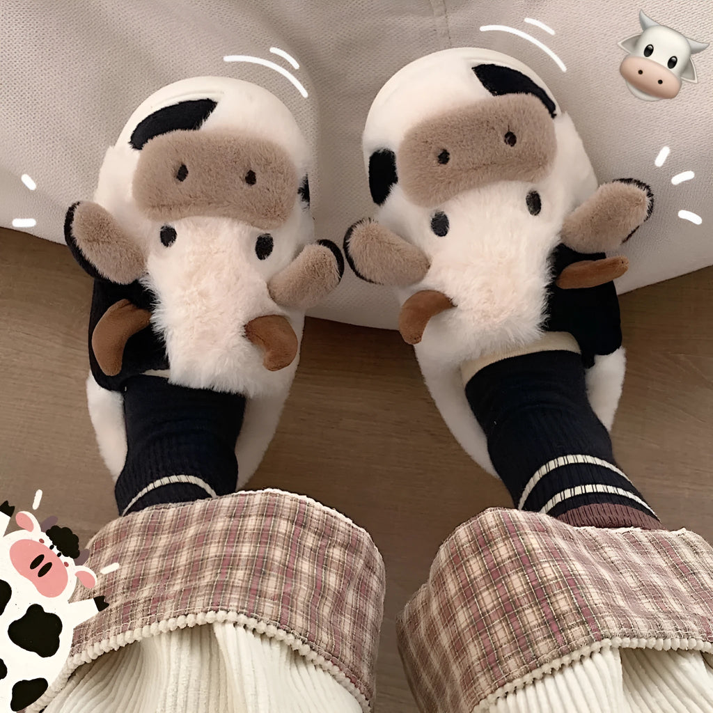 White women's cow slippers with fluffy faux fur, cartoon face, and textured non-slip sole.