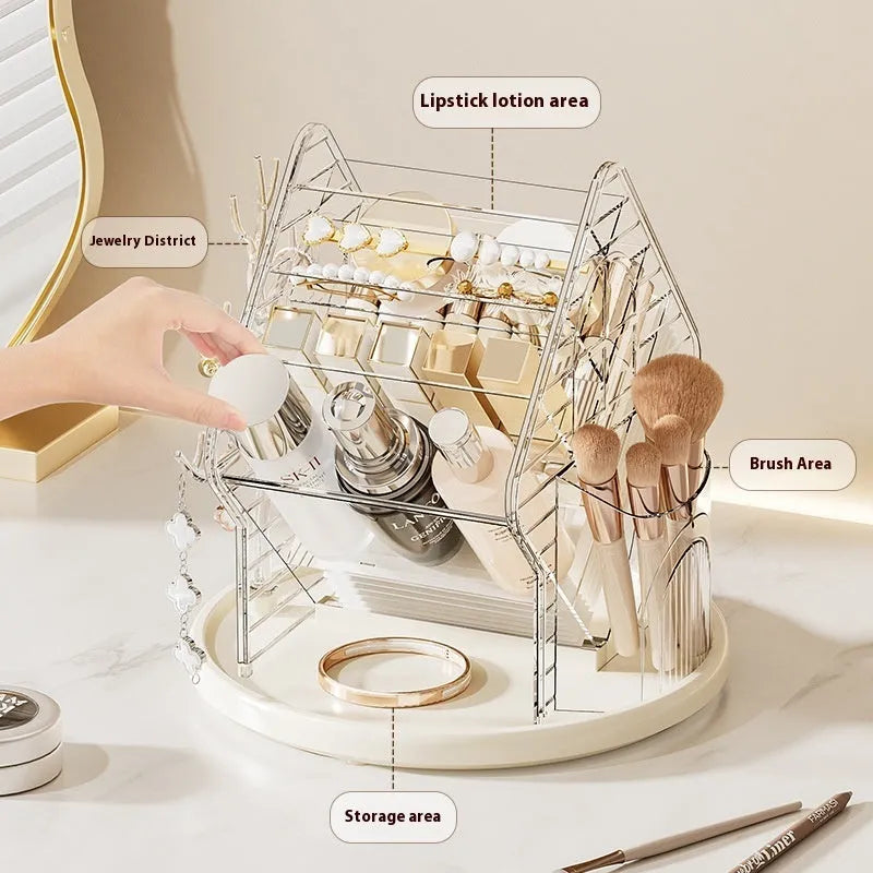 Rotating clear plastic cosmetics organiser box with multiple tiers on a wooden dresser.