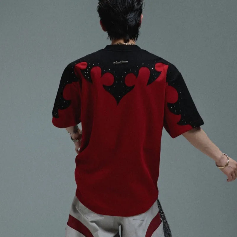Grey men's T-shirt with raised black floral embroidery and rhinestone details on a dropped shoulder, loose-fit design.