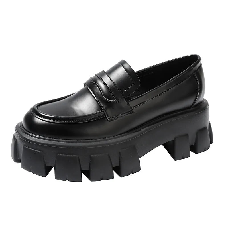 British style wide-fit patent leather loafers with a distinctive muffin heel on a rubber sole.