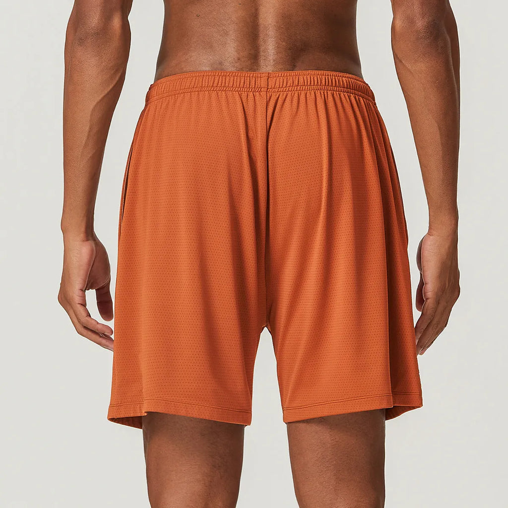 Men's quick-dry double-layer running shorts in a brick red colour on a mid-waist fit model.