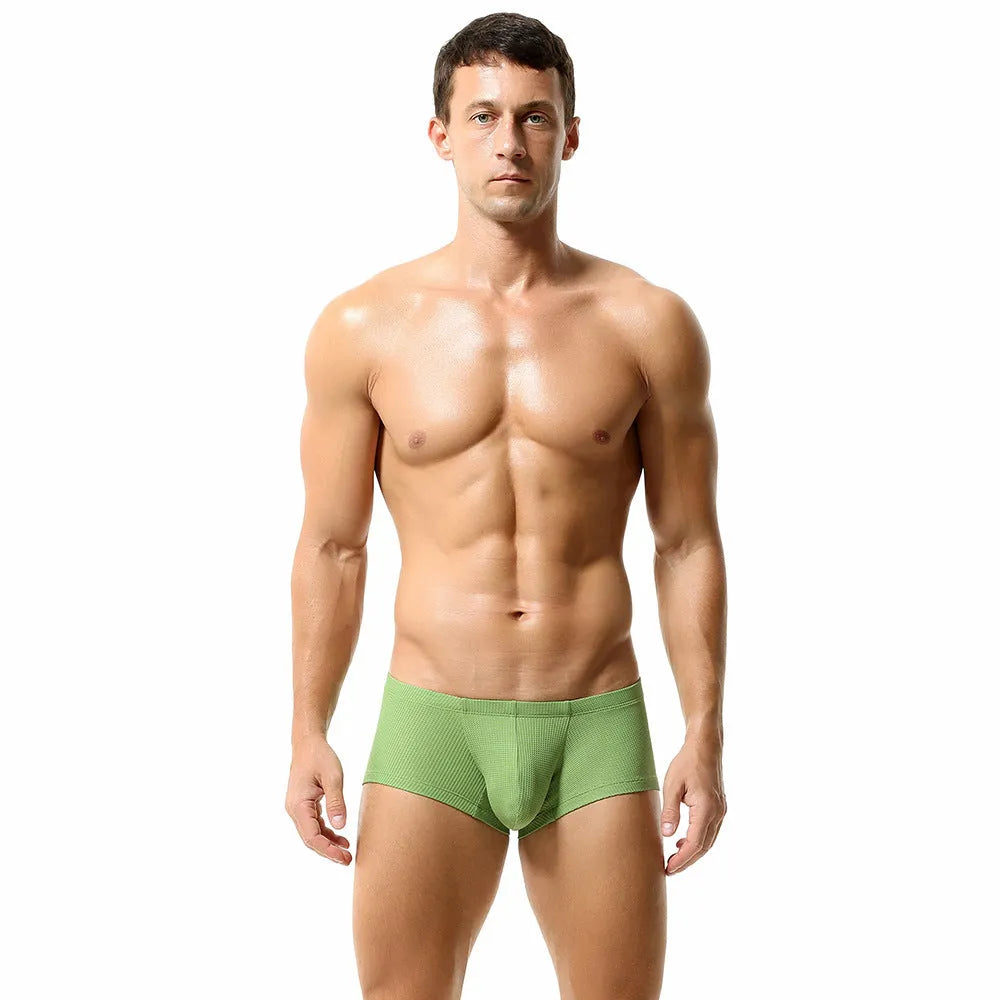 Solid colour low waist men's boxers in nylon fabric on a white background