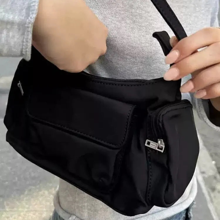 Black nylon lightweight shoulder bag with double pockets showing side line design detail