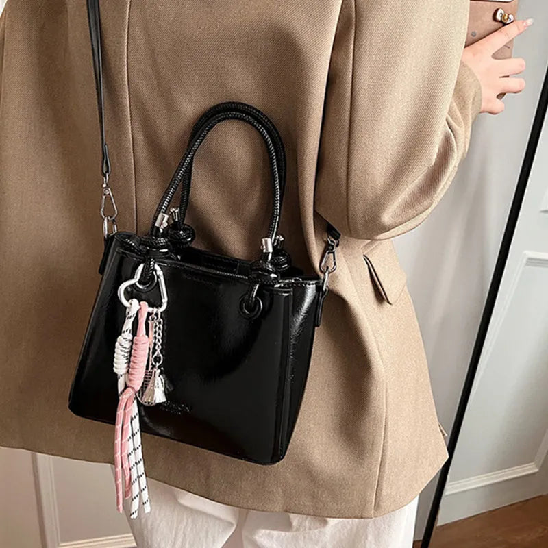 Women's medium-soft PU messenger bag in bucket shape with pendant, black, white, wine red, and pink options