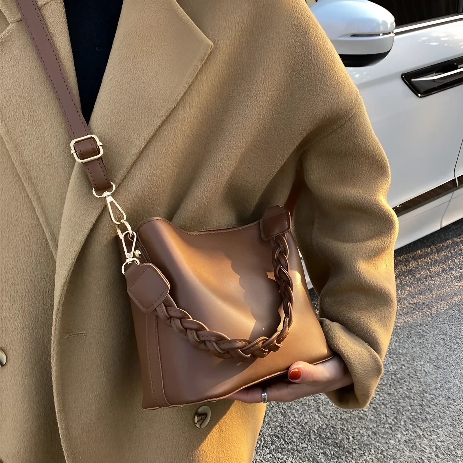 Retro style khaki crossbody bucket bag with weaving detail on the front.