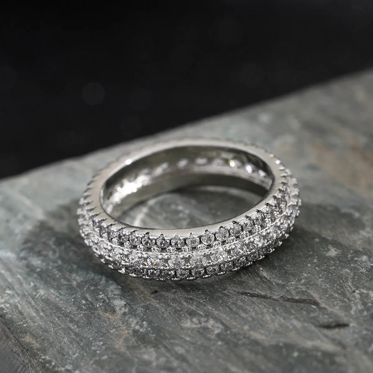 Geometric personalised ring with triangular design and zircon stone, shown in a gold colour finish.