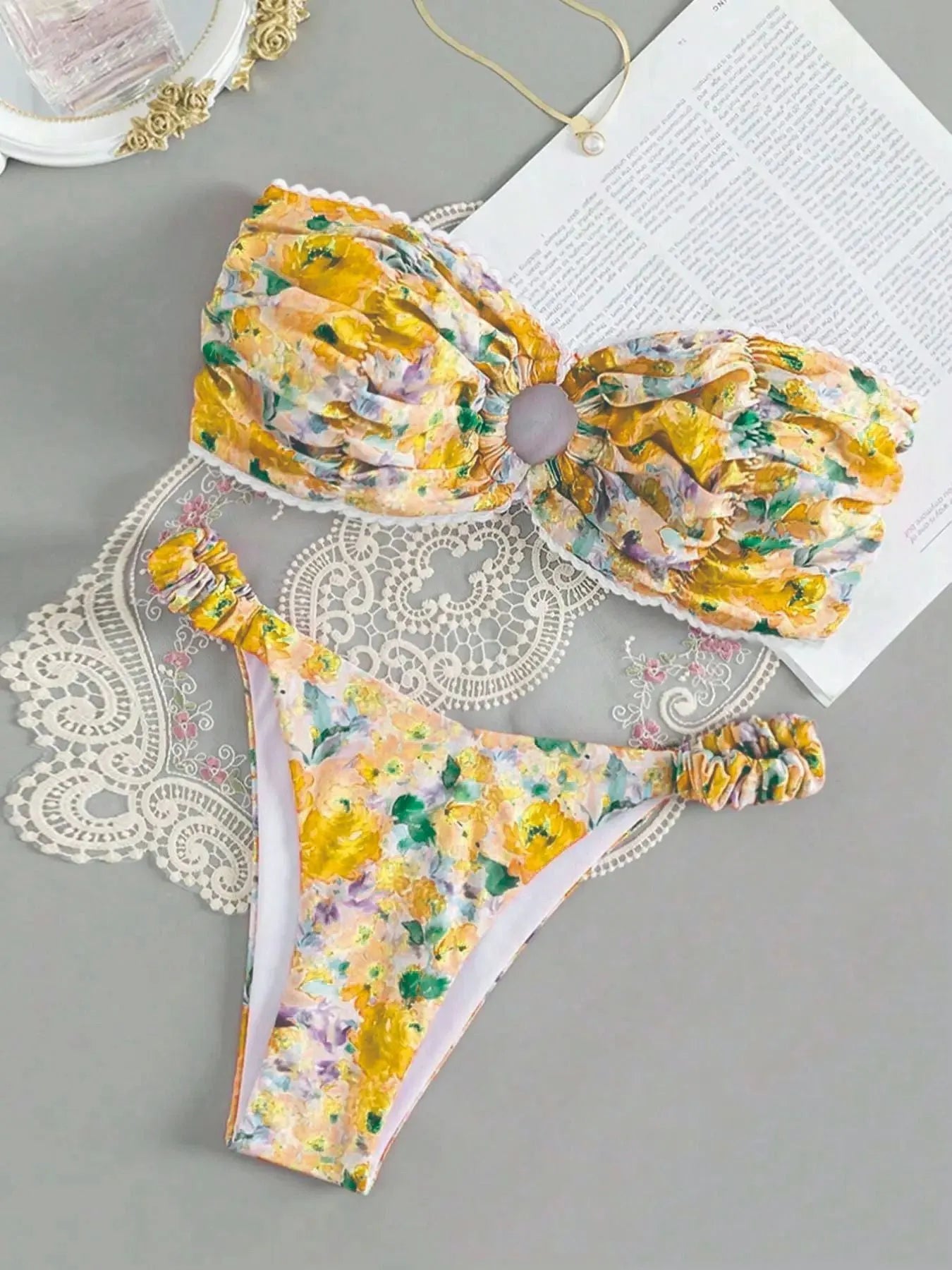 Blue floral print bikini set with lace trim on a sleeveless tube top and matching briefs.