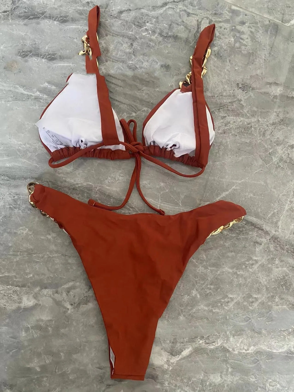 Brown women's tube-top bikini with adjustable ring tether at the back and push-up padding.
