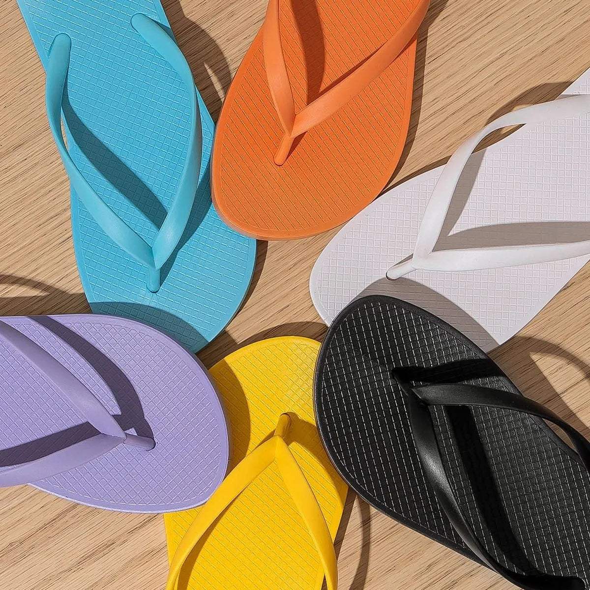 Foldable beach slippers with non-slip PVC soles in orange, purple, black and white colours